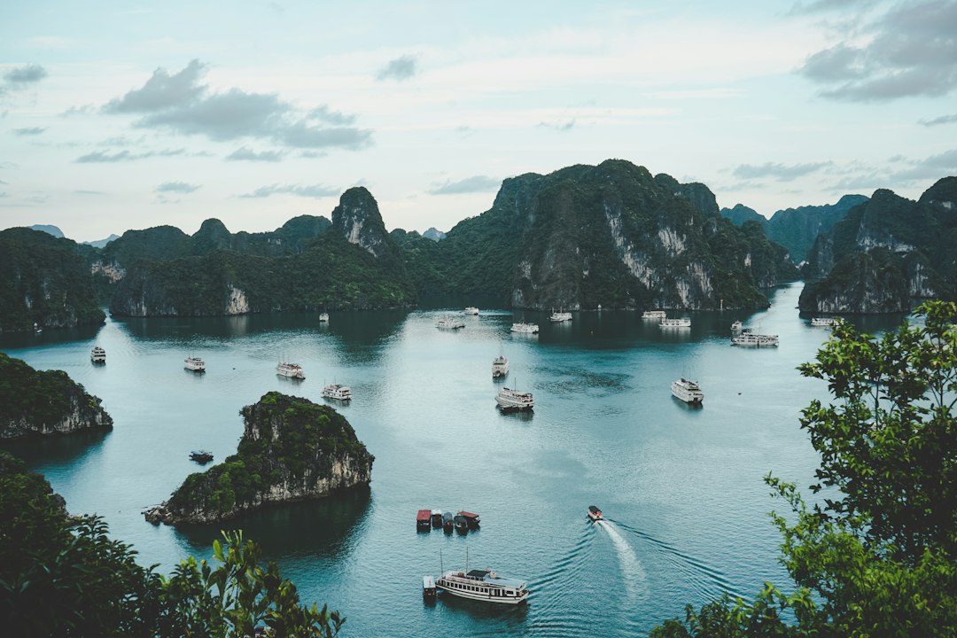 Aerial view of Ha Long Bay Vietnam with limestone karst islands and cruise boats on turquoise water